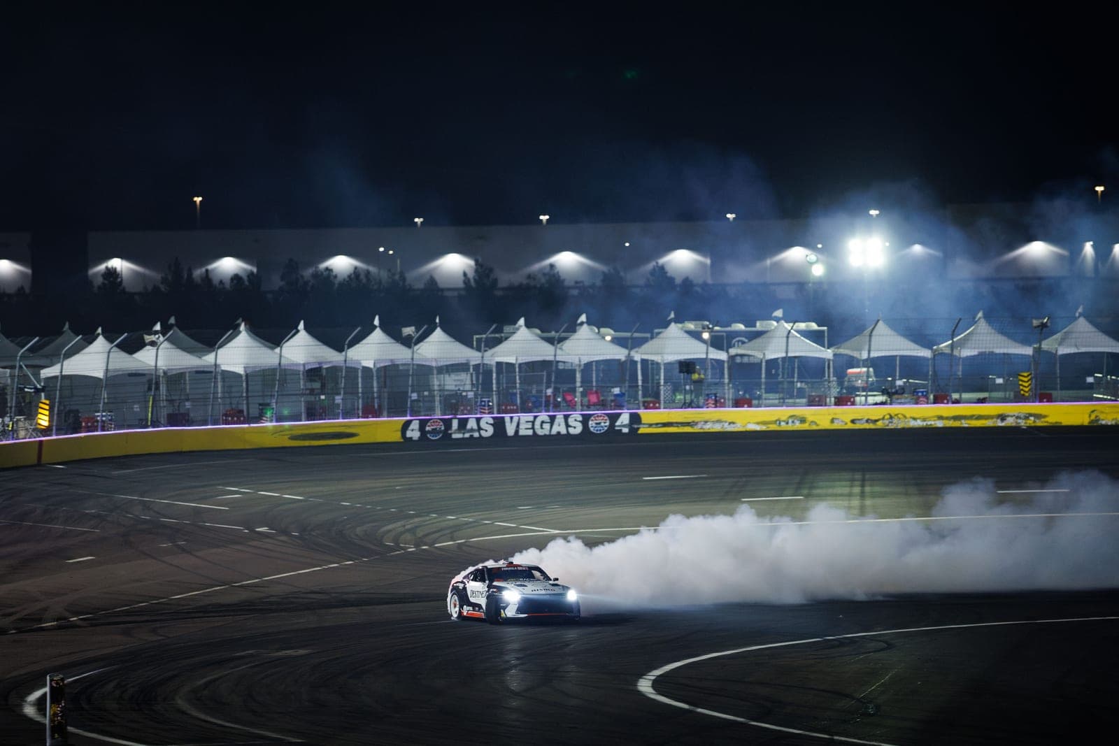 The Forsberg Racing Nissan Z drifting at the illuminated LVMS Bullring