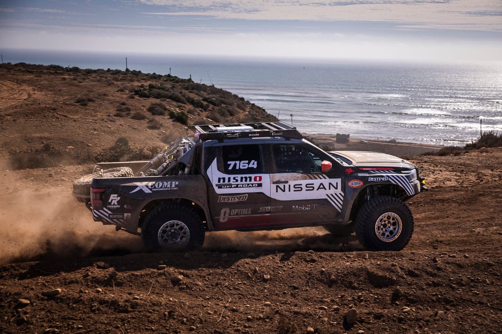 The No. 7164 Nissan Frontier racing along the Baja coastline