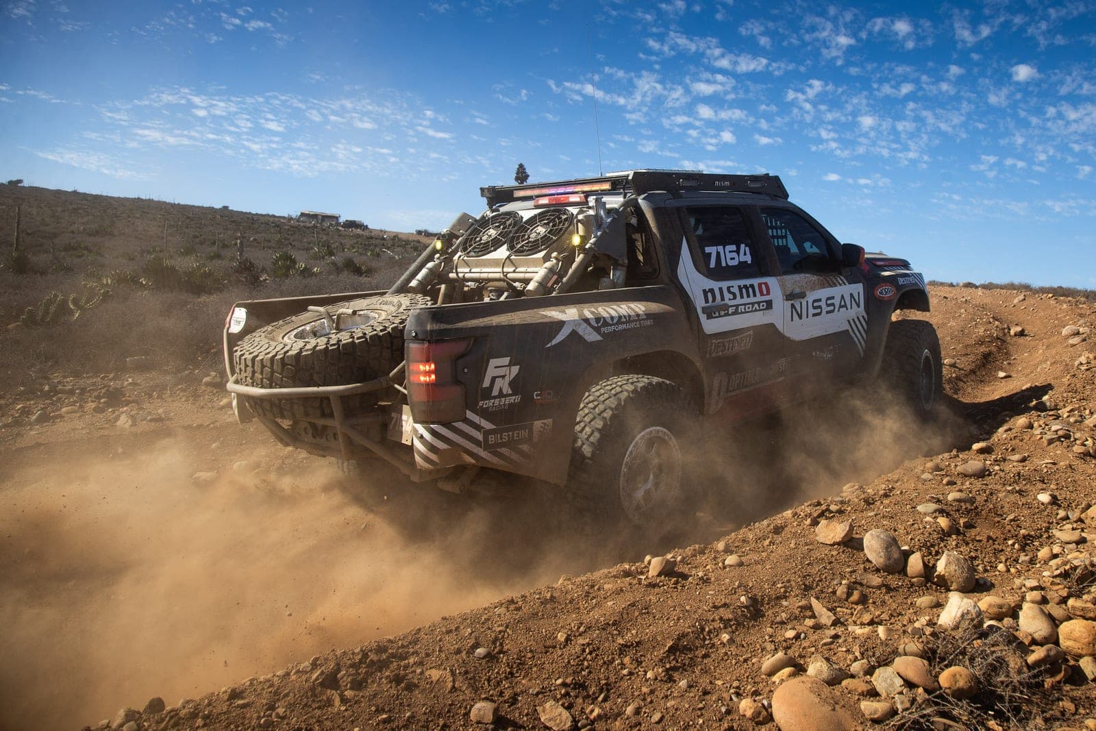 The Nissan Frontier crossing rough Baja terrain at the NORRA 500